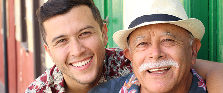 Smiling son with arm around his father.