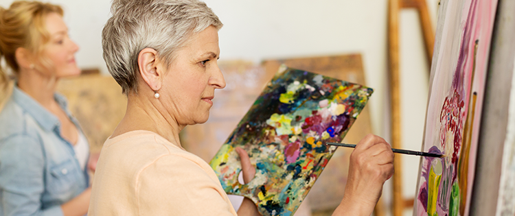 Woman painting in an art class