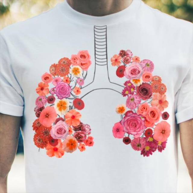 An image of a person wearing a t-shit with and image of lungs made of flowers