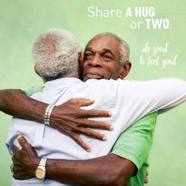 Image of two older men hugging. The caption reads, "Share a hug or two. Do good to feel good."